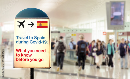a signal inside an airport that warns about what to know before flying to Spain during the Covid-19 pandemic