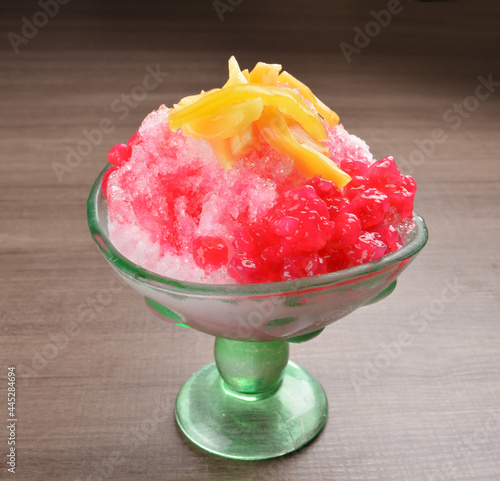 asian snow iced kacang with red ruby mango fruit  and sweet sugar syrup in glass Thai dessert halal menu photo