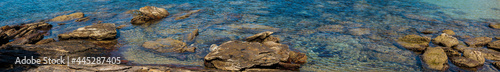 panorama of stones and corals in clear waters