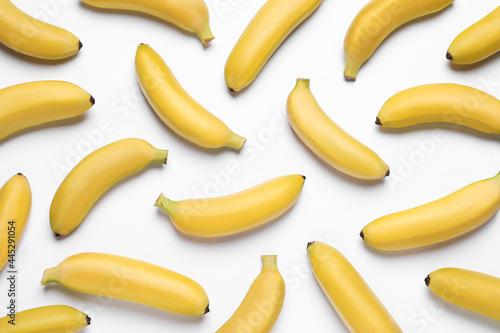 Sweet ripe baby bananas on white background, top view
