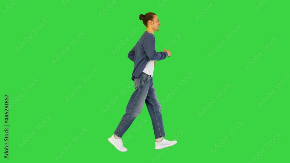 Young white man runs smiling on a Green Screen, Chroma Key. Young white man runs smiling on a Green Screen, Chroma Key.
