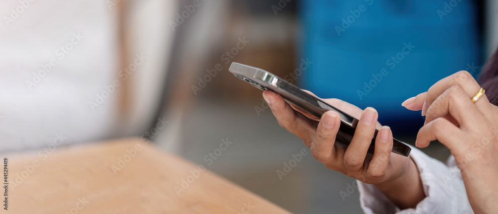 Close up of woman using cellphone and typing text message on smartphone device Close up of woman using cellphone and typing text message on smartphone device