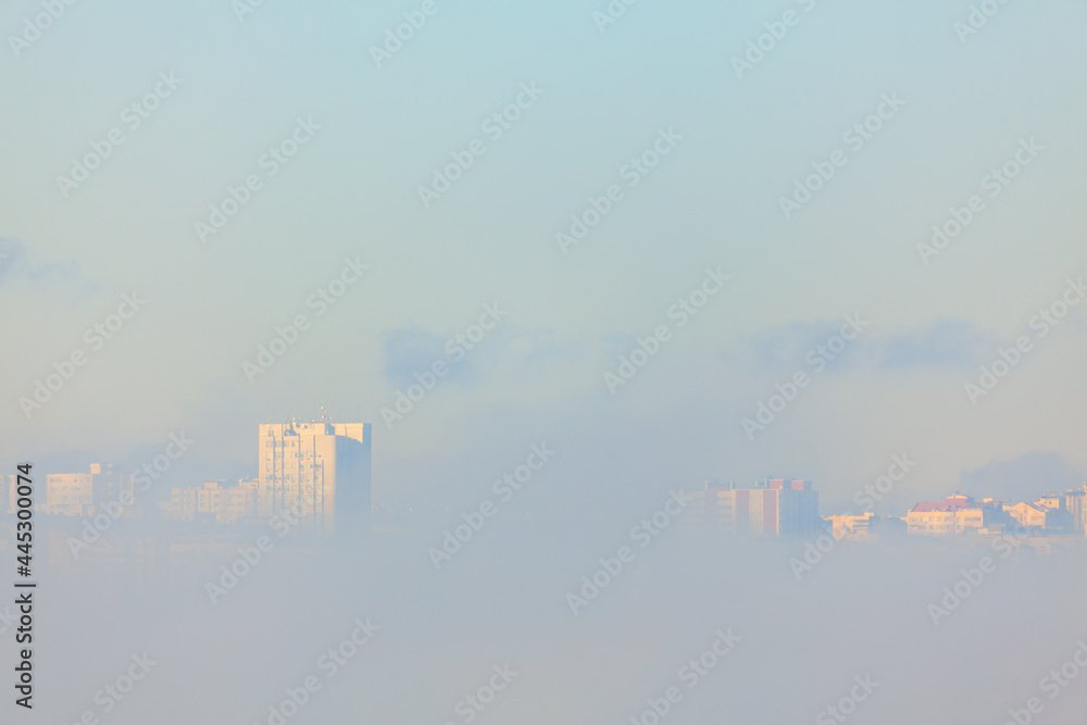 City in fog . Houses in the clouds 