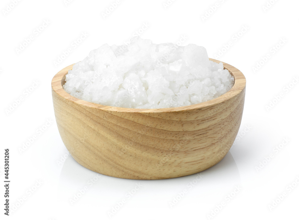 Closeup coarse or rock natural sea salt in wooden bowl isolated on white background. Clipping path. 