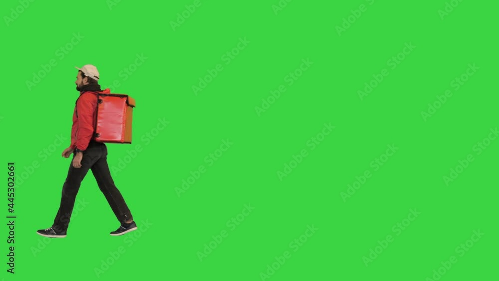 Male courier walking by with thermo bag on a Green Screen, Chroma Key. Male courier walking by with thermo bag on a Green Screen, Chroma Key.