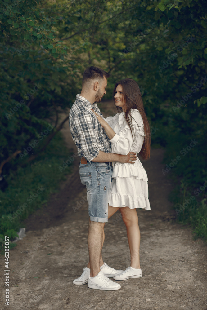 Fototapeta premium Beautiful couple spend time in a summer park