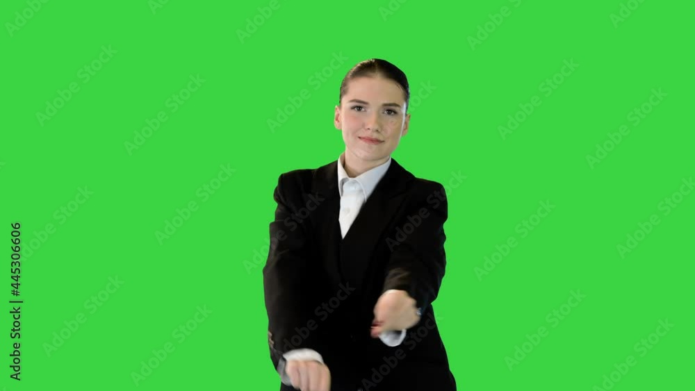 Young woman in office suit dances waving her arms on a Green Screen, Chroma Key. Young woman in office suit dances waving her arms on a Green Screen, Chroma Key.