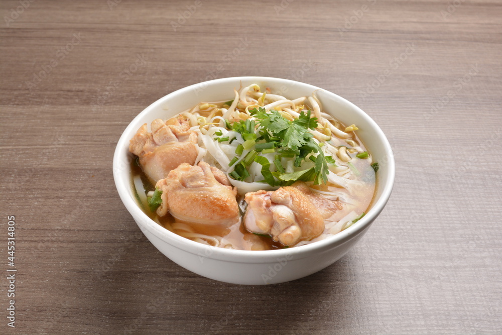 cook clear hot soup with chicken meat, vegetable and noodle on wood background asian halal menu cook clear hot soup with chicken meat, vegetable and noodle on wood background asian halal menu