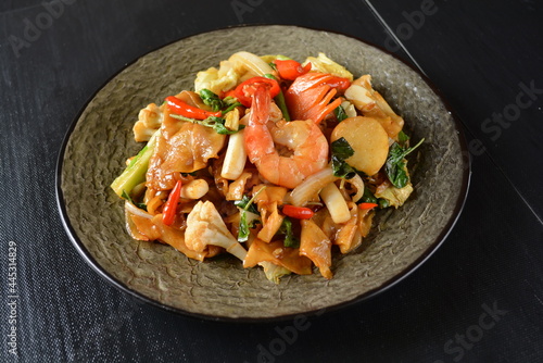 stir fried noodle kway teow with seafood phad Thai on wood background asian halal menu