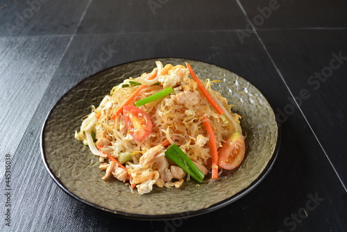 stir fried noodle vermicelli with seafood phad Thai on wood background asian halal menu