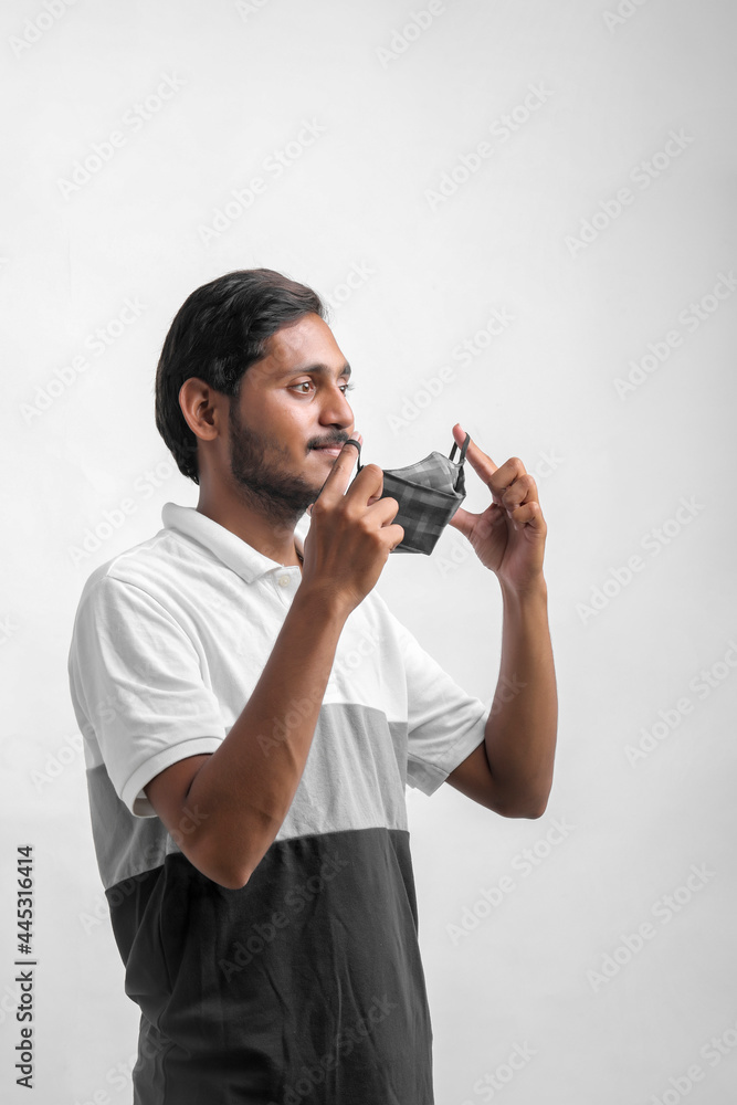 young indian man wearing mask for protection against virus. young indian man wearing mask for protection against virus.