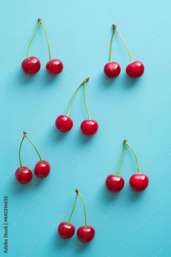 Cherry berries on blue background top view Cherry berries on blue background top view