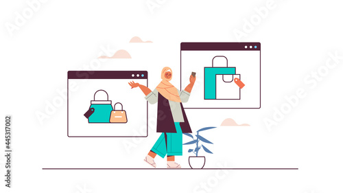arab woman using smartphone buying and choosing things in online store sale consumerism online shopping