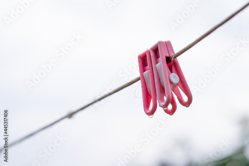 Double pink clothespins on cables on a rainy day