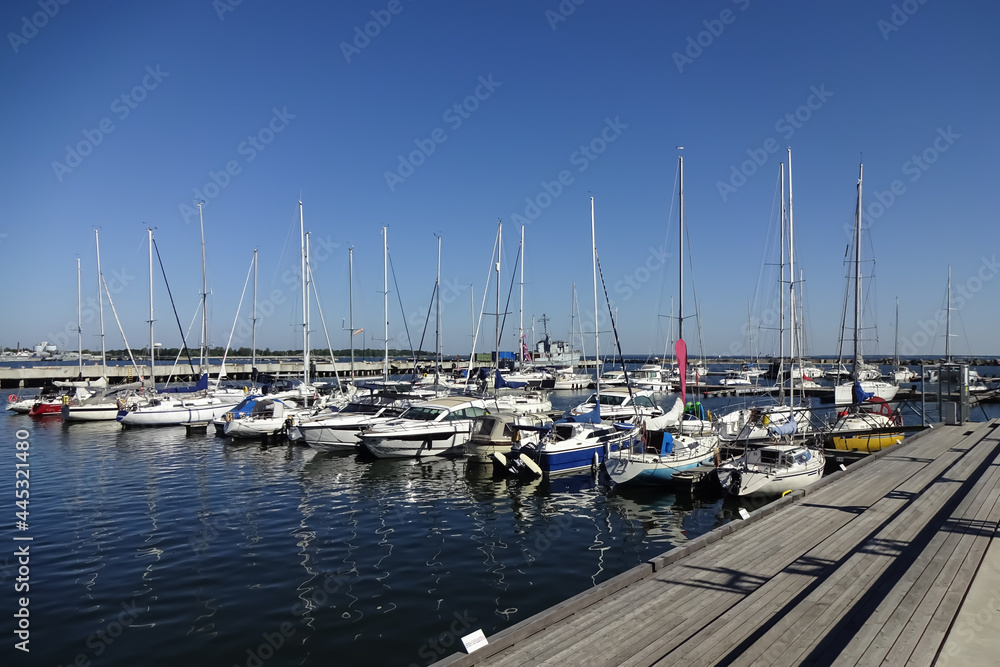 Seaview in the area of Maritime museum in Seaplane Harbour (in Estonian Lennusadam). Yachts and sailing boats on the dock. A sunny summer day with a clear blue sky. Tallinn, Estonia