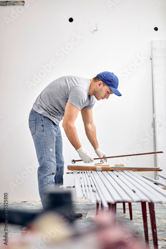 Young adult man working on a DIY budget renovation of his new home apartment.