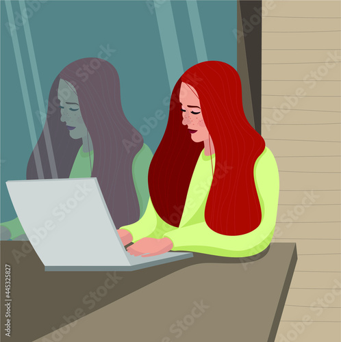 A blogger girl is working at a laptop in a summer cafe ,her reflection is visible in the glass.