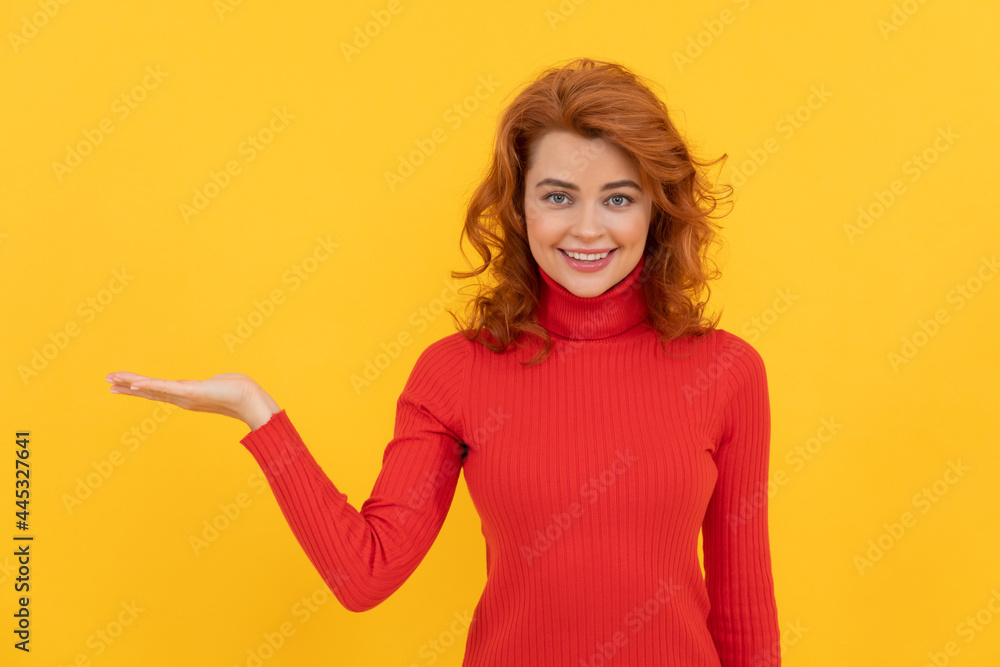 cheerful redhead girl make choice presenting product with copy space for advertisement, advertising. cheerful redhead girl make choice presenting product with copy space for advertisement, advertising.