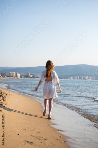 young girl running on the beach © Liubov Kartashova