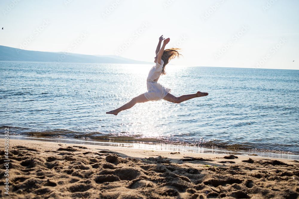 woman running on the beach, dancing and jumping on the beach woman running on the beach, dancing and jumping on the beach