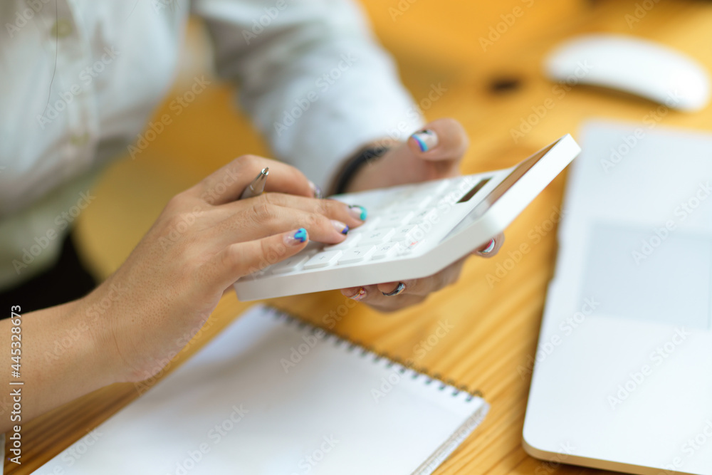 Fototapeta premium Close up casual female using calculator, accountant using calculator