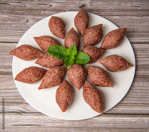 Traditional kebbe and pita bread on big round plate in lebanese restaurant. High quality photo photo