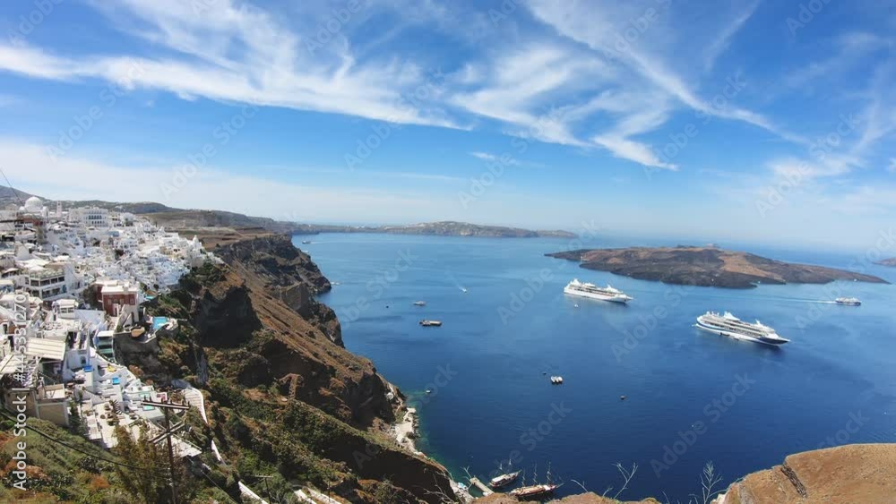 Panoramic view with Cruise ships in Thira on Santorini island, Greece, Kameni volcano island at background Panoramic view with Cruise ships in Thira on Santorini island, Greece, Kameni volcano island at background