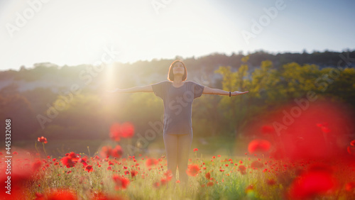 Young beautiful woman with raised arms in spring field © YURII Seleznov