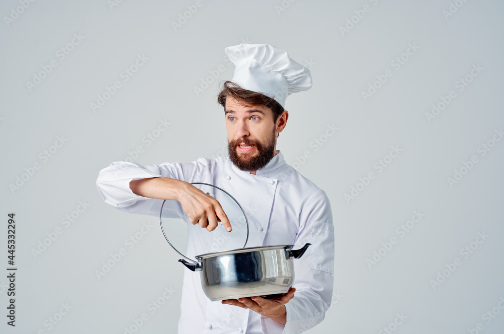 Cheerful chef with saucepan in hands kitchen cooking light background Cheerful chef with saucepan in hands kitchen cooking light background
