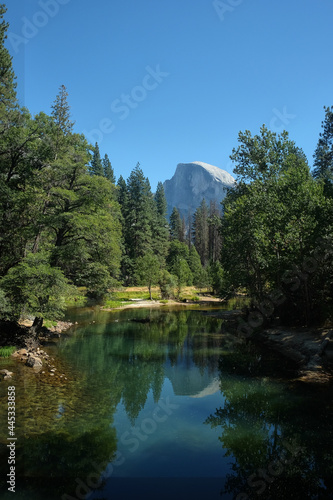Merced River passing through the Yosemite Valley in the background is half dome mountain in Yosemite National Park, California, United States
