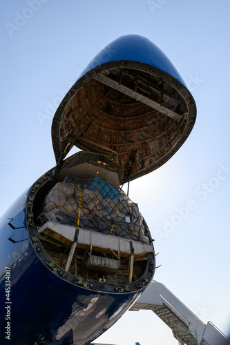Nose of cargo compartment in the plane standing at the airport. Unloading wide-body cargo aircraft