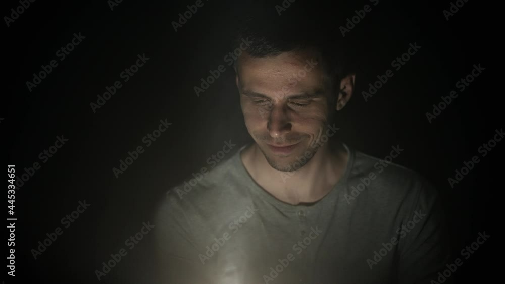 Man looking at something glowing Man looking at something glowing