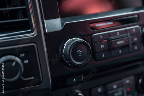 Car radio front volume close-up. Modern car audio system. Car radio controls.