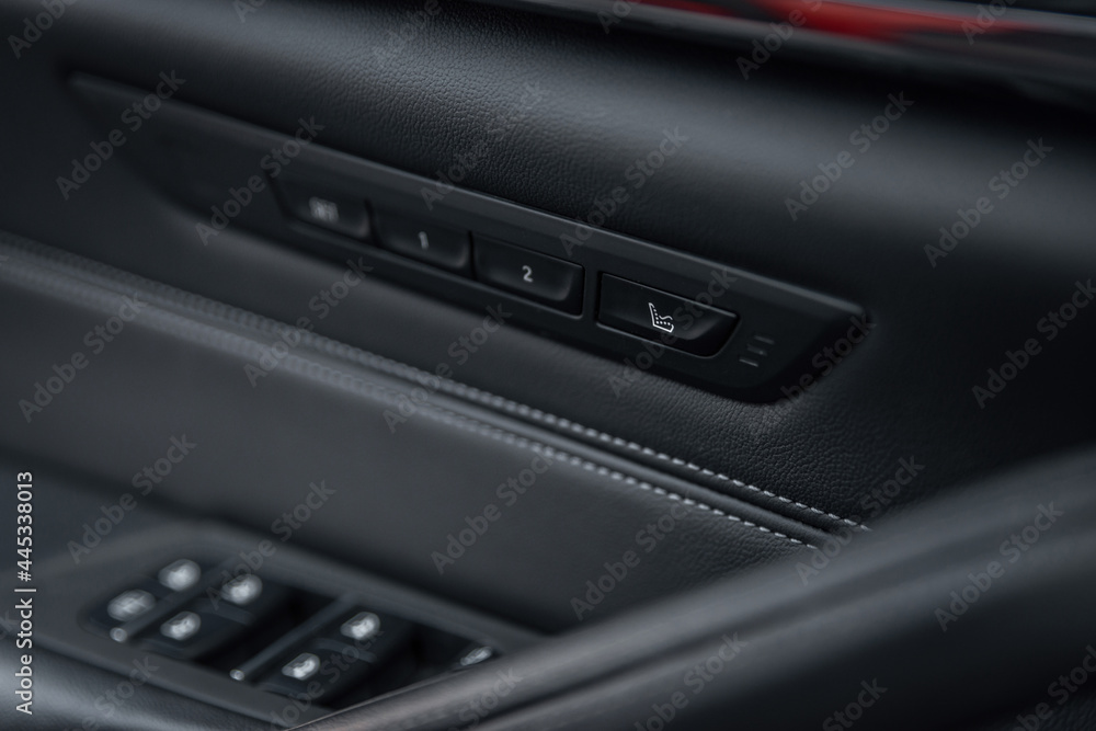 Car seat massage control panel. Massagers button. Close-up of the luxury car black interior. Car seat massage control panel. Massagers button. Close-up of the luxury car black interior.