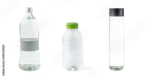 set of various plastic and glass bottles with spring clean water on white background isolated. Selective focus. Assortment for online delivery shop. Copy space for your text