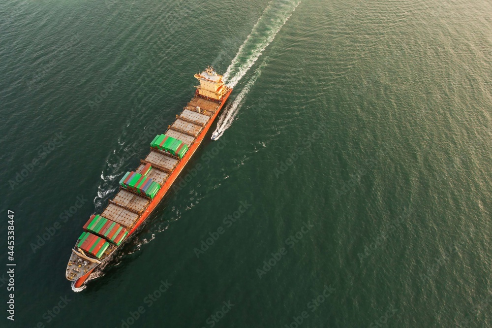 Container ship in export and import business and logistics. Shipping cargo to harbor Water transport International. Aerial view and top view.