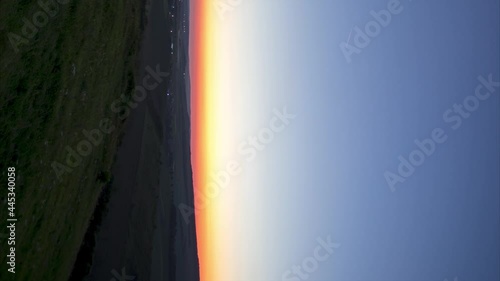 Timelapse Night to Day Transition of moon setting over city lights, vertical video