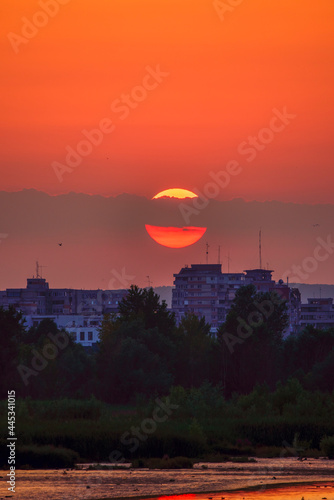 beautiful landscape with a sunset over the buildings of a city