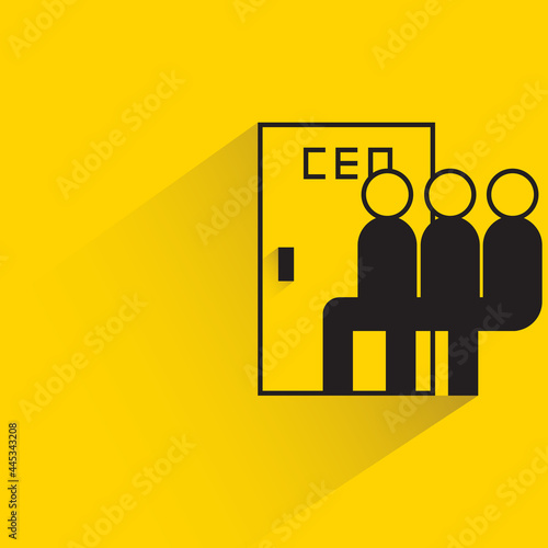 employee sitting next to ceo door on yellow background