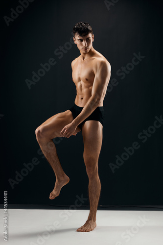 athletic male bodybuilder with muscular body black panties studio