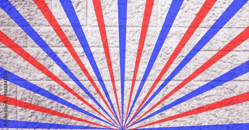 Digitally generated image of red and blue radial rays against brick wall in background