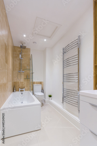 A stylish modern bathroom with bath built in shower and toilet
