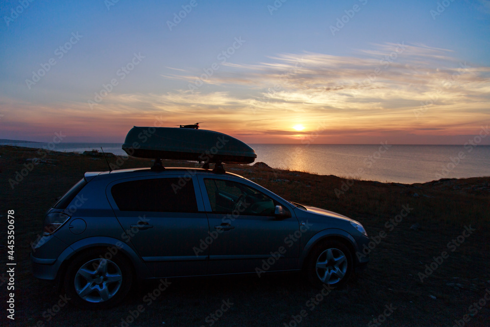 a trip to the sea by car. car on the beach sunset