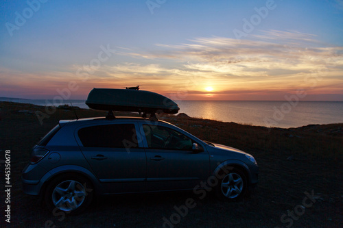 a trip to the sea by car. car on the beach sunset