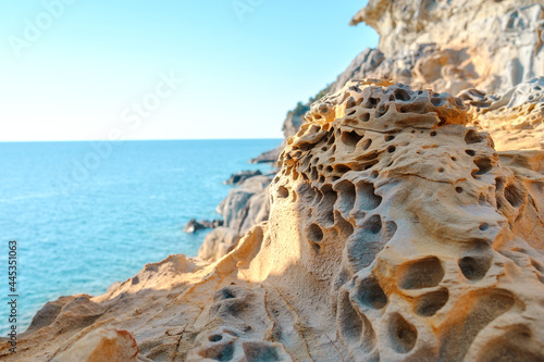 Eroded rocks and Tirrenian sea in Baratti, Tuscany, Italy. Cliff Buca delle Fate. Tourism destination. photo