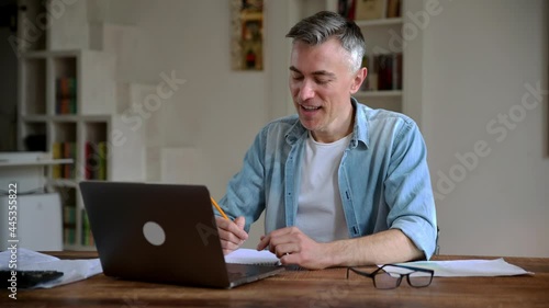 Wallpaper Mural Positive successful adult gray haired caucasian broker, freelancer or manager wearing glasses, working remotely, talking by video call with client or employee, having online conference,smiles friendly Torontodigital.ca