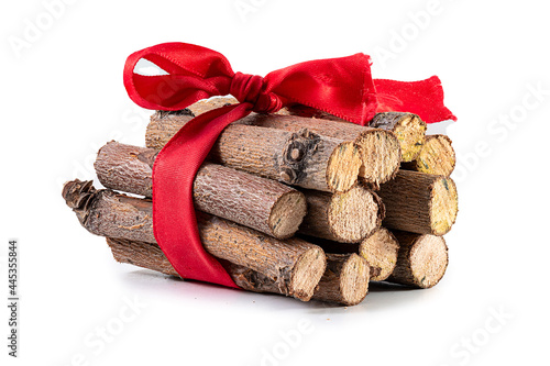 firewood logging. pile of firewood isolated. timber storage of prepared firewood, a bunch of logs, hardwood; Sawed firewood in forest logs close up with red ribbon