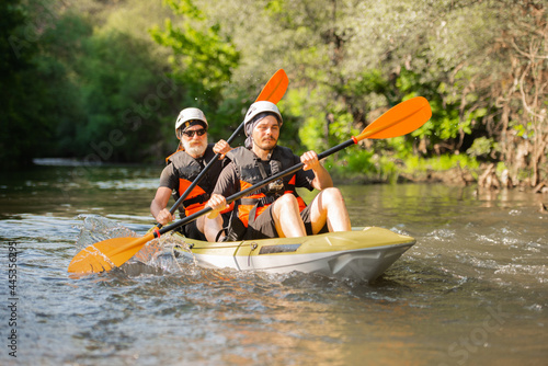 Wallpaper Mural Senior and young guy canoeing together Torontodigital.ca