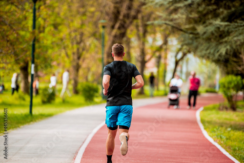 Caucasian young manjogging and focused on winning the race