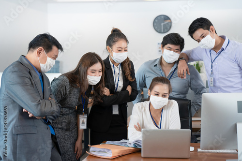 Asian business team with face mask protect from Coronavirus
